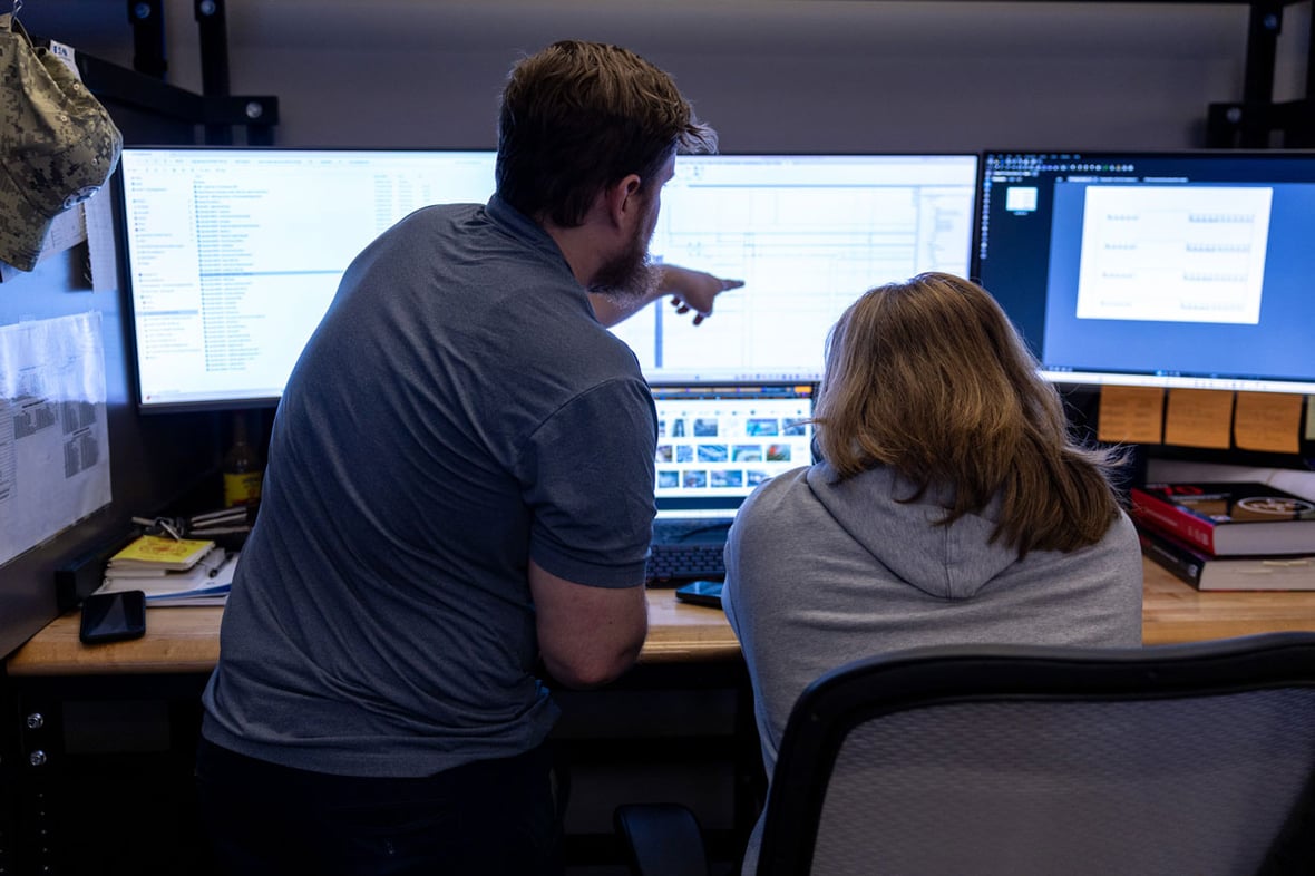 two men working on engineering project at a desk