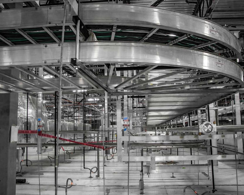 inside view of a manufacturing facility with metal conveyors