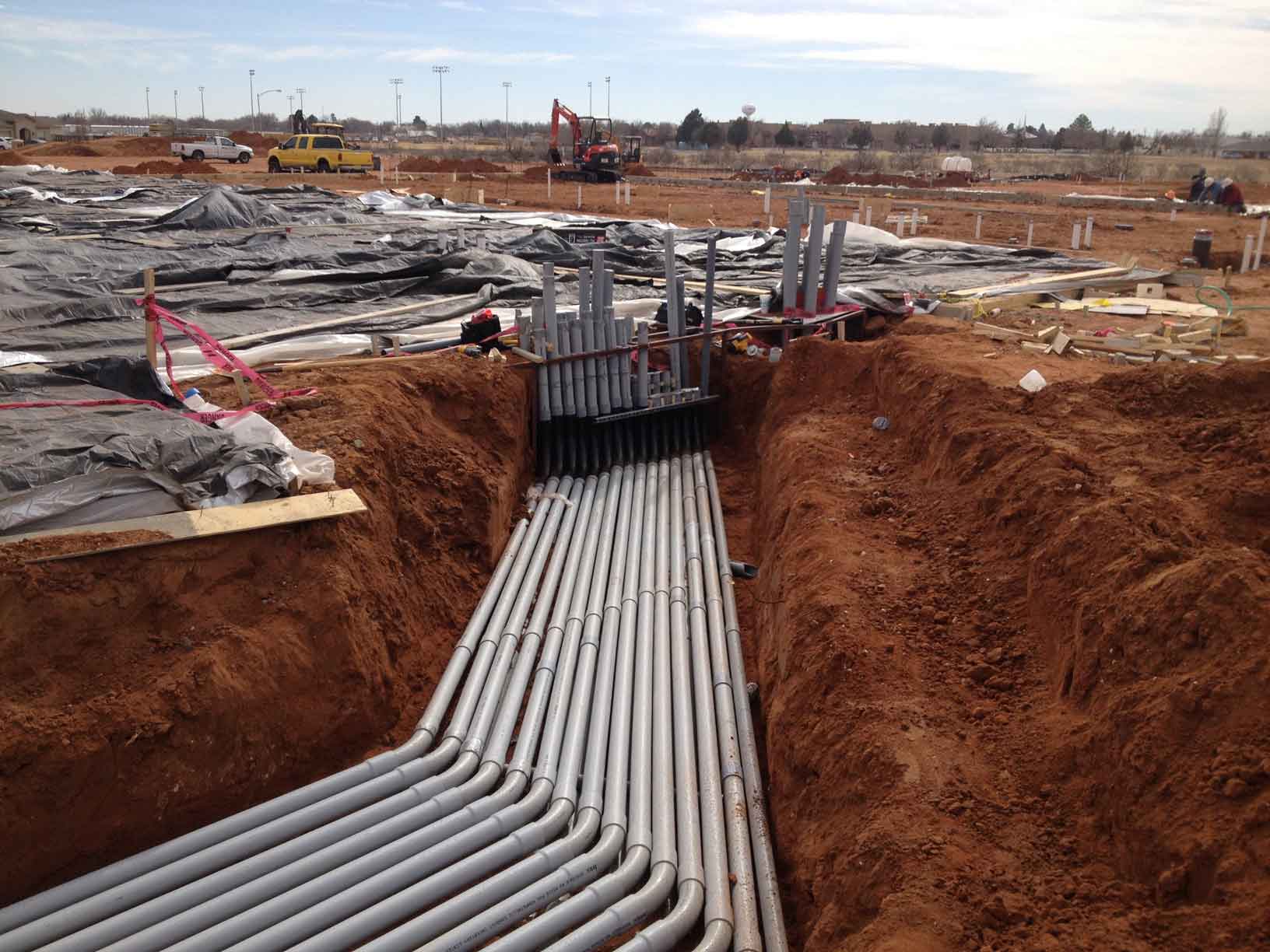 outdoor dirt trenches with conduits routed inside