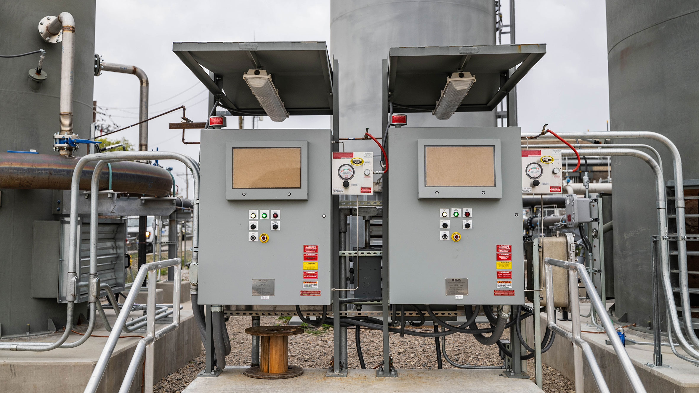 An expansive industrial gas plant with two electrical boxes