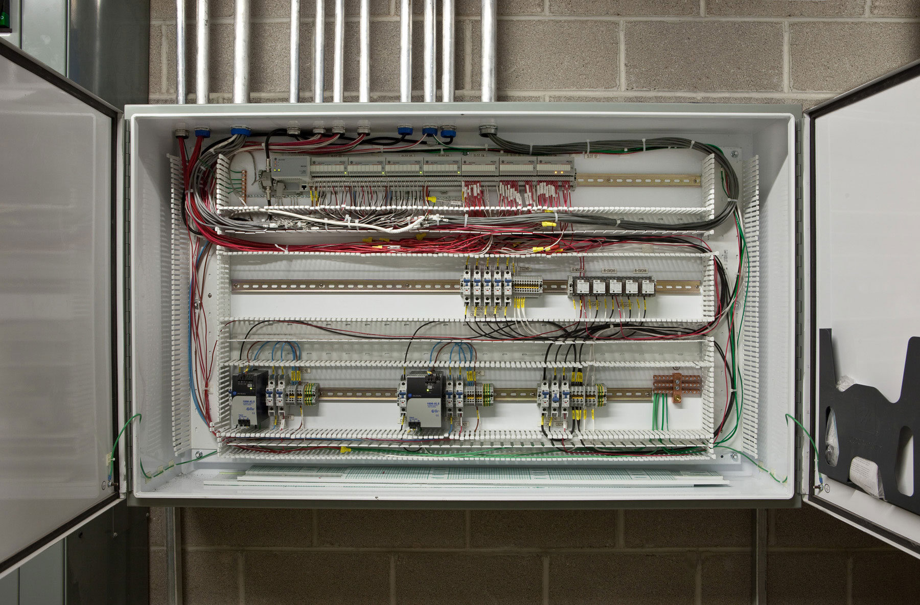 An open cabinet displaying wires and electrical components