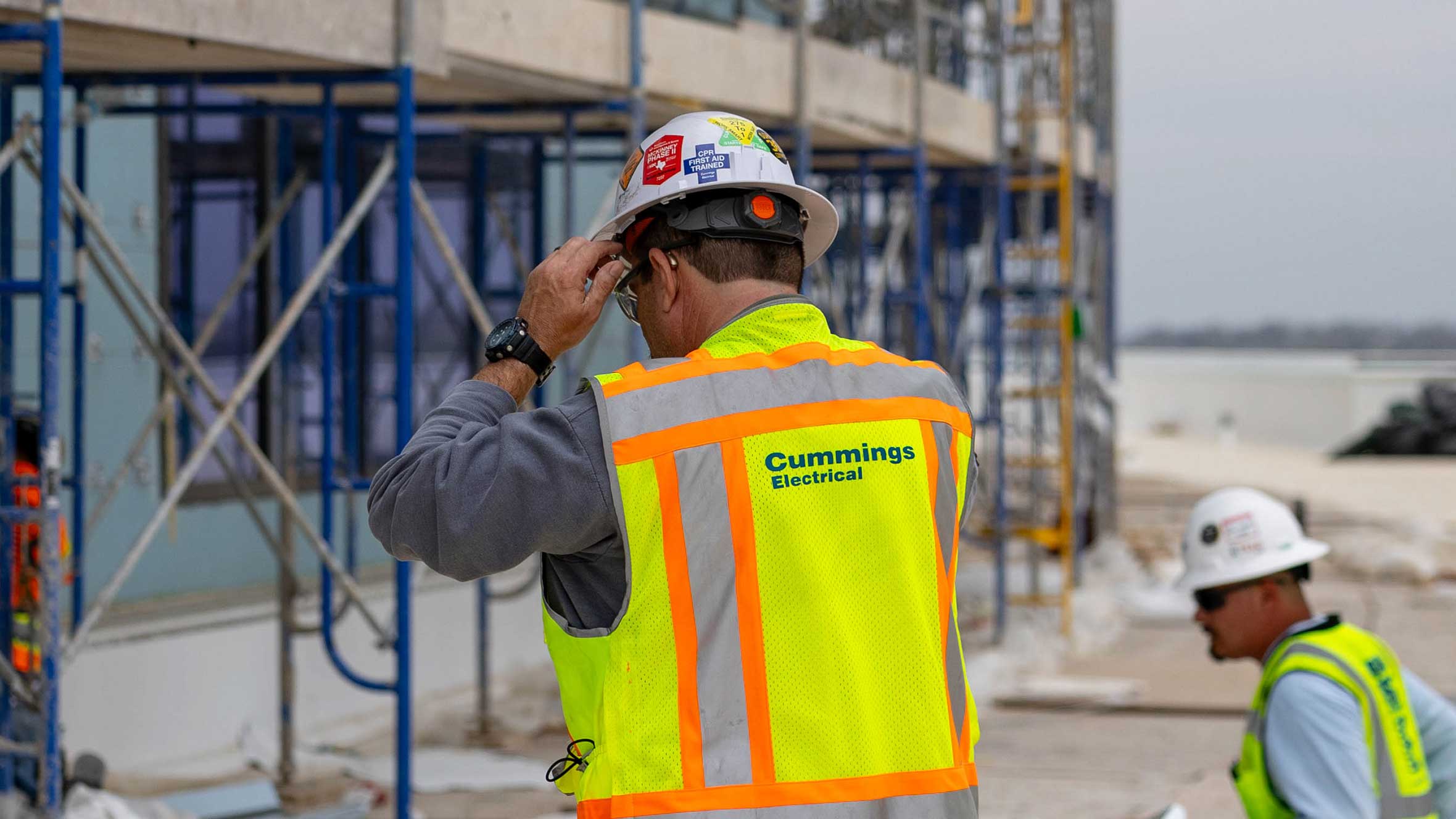 Construction workers diligently engaged in their tasks at a job site, showcasing teamwork and industry effort