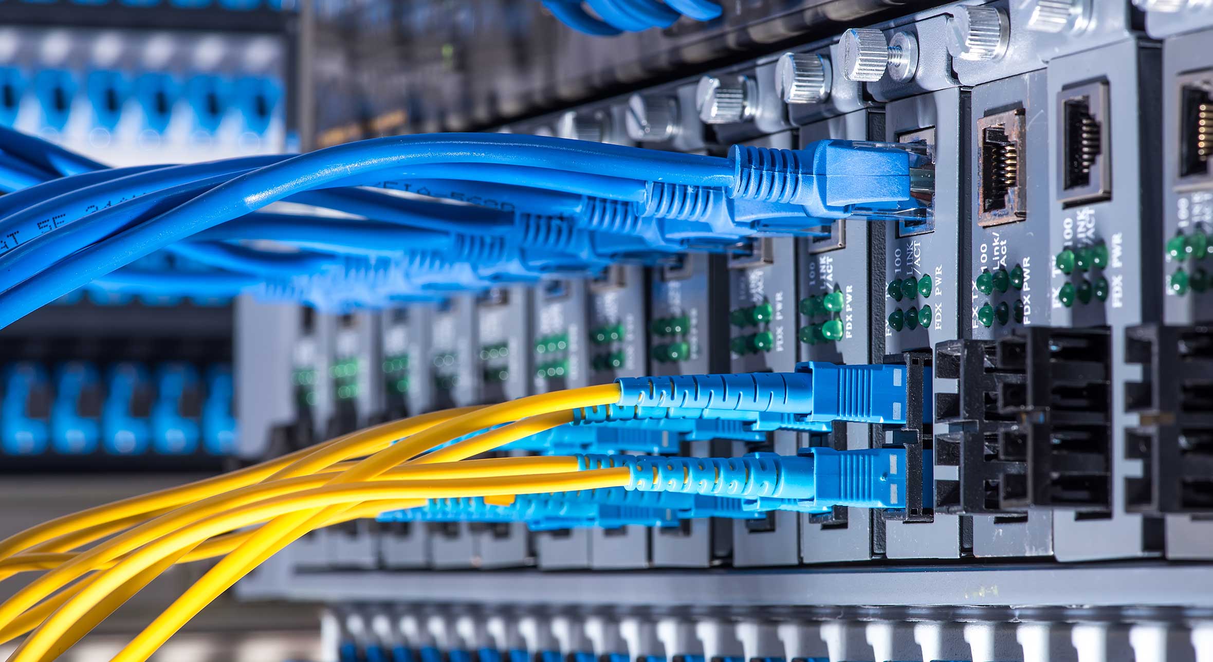 Fiber Optic cables connected to an optic ports and Network cable