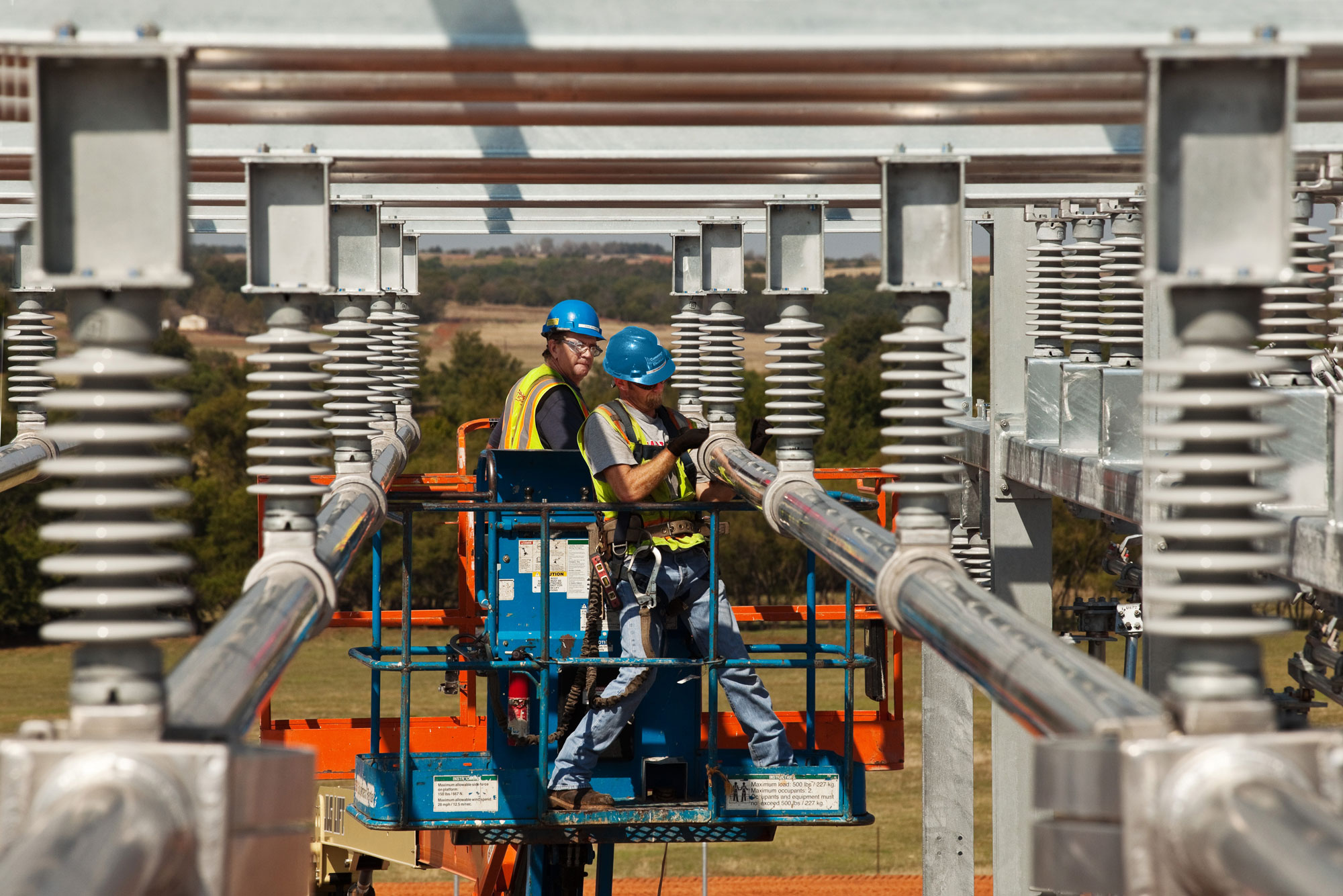 Cummings technicians working on elevated electrical substation gear