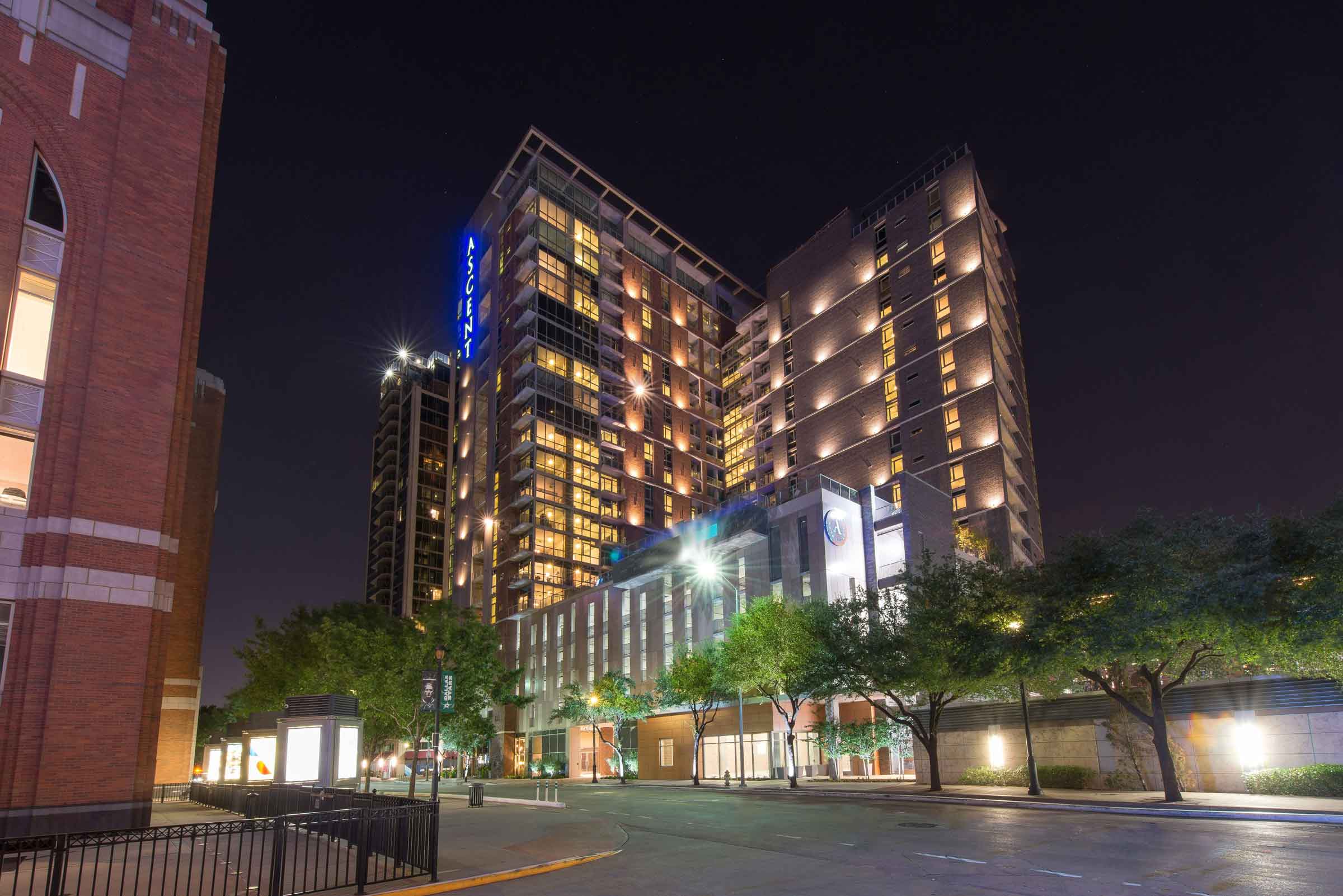 Modern nighttime view of a well-lit, high-rise hotel building