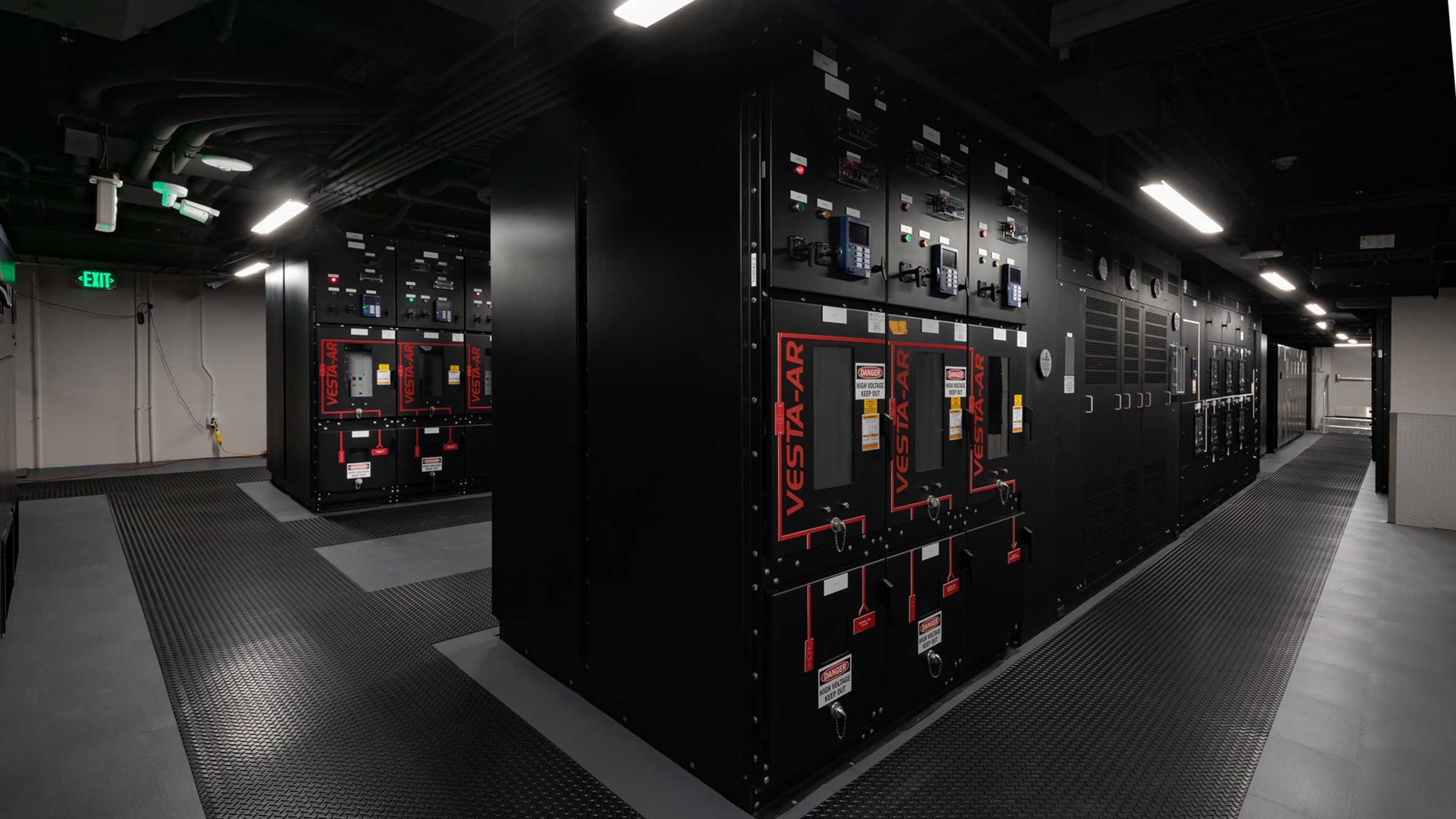 Sleek indoor view of multiple black and red data center panels