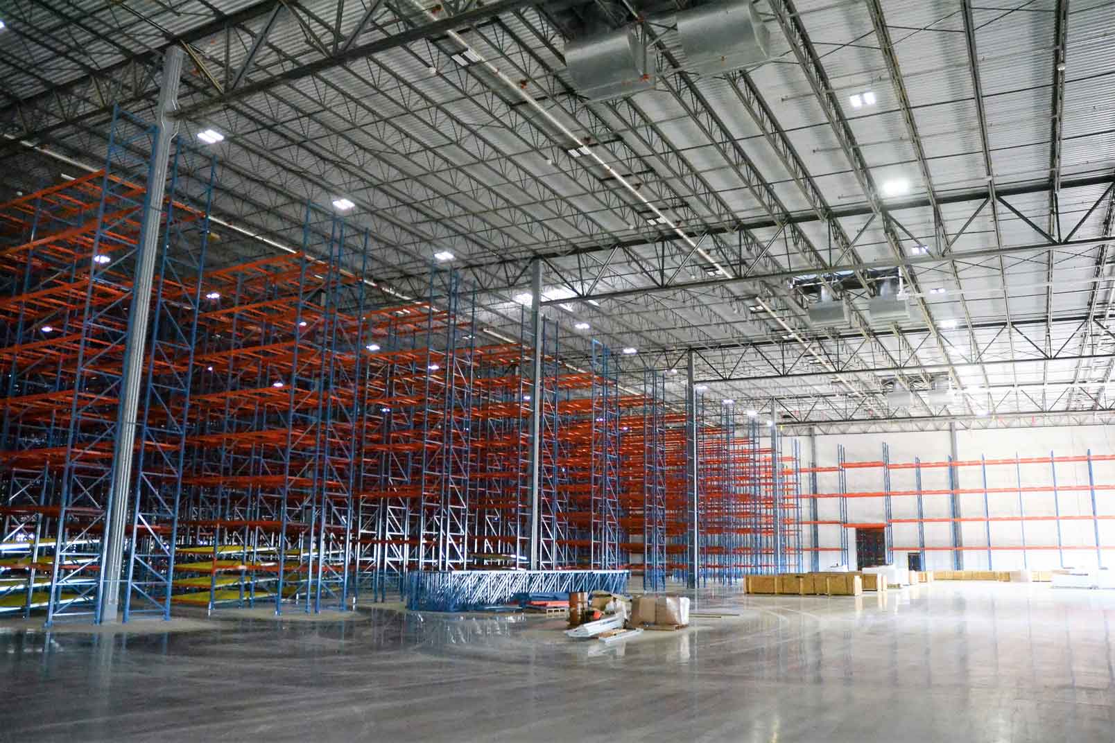 Empty distribution warehouse with rows of tall storage racks