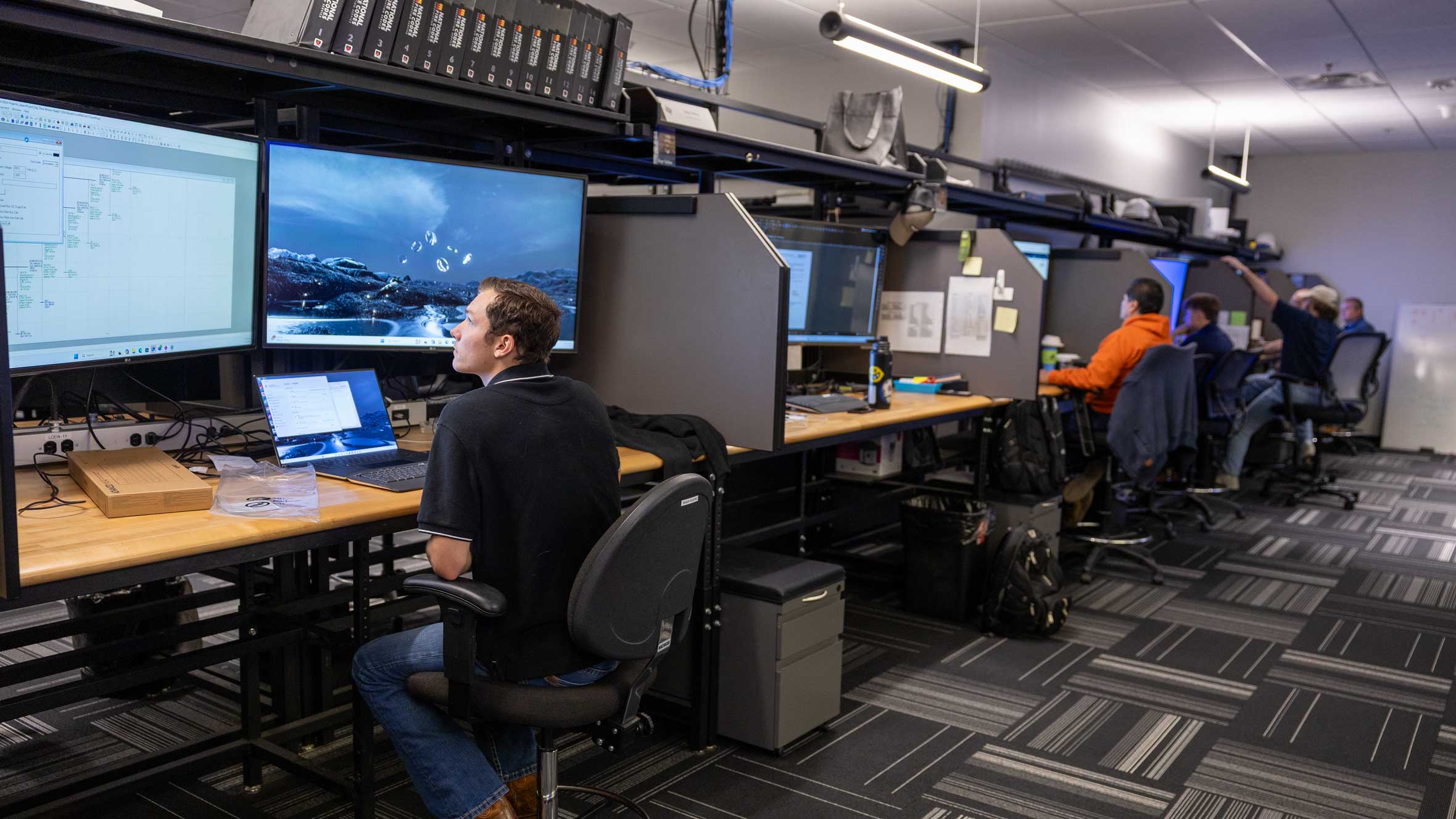 row of Cummings engineering and designer team desks and professionals