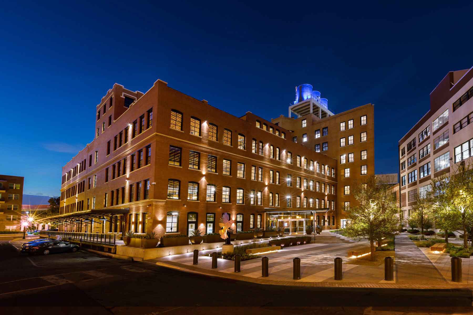 nighttime view of a historic building surrounding a community space