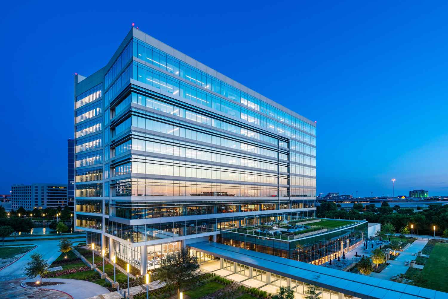 Modern high-rise office building with lighting throughout the building