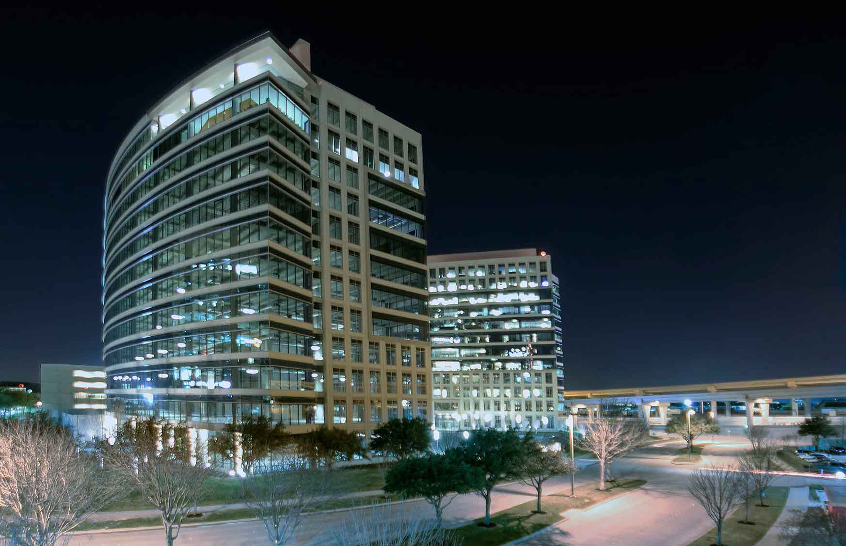 Modern high-rise building with multiple lights illuminating the inside and outside