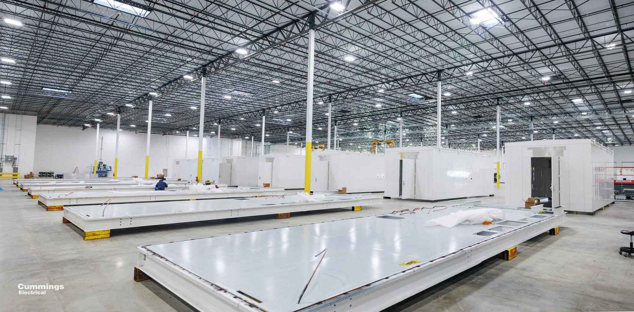 Manufacturing facility assembling prefabricated e-houses for large-scale deployment