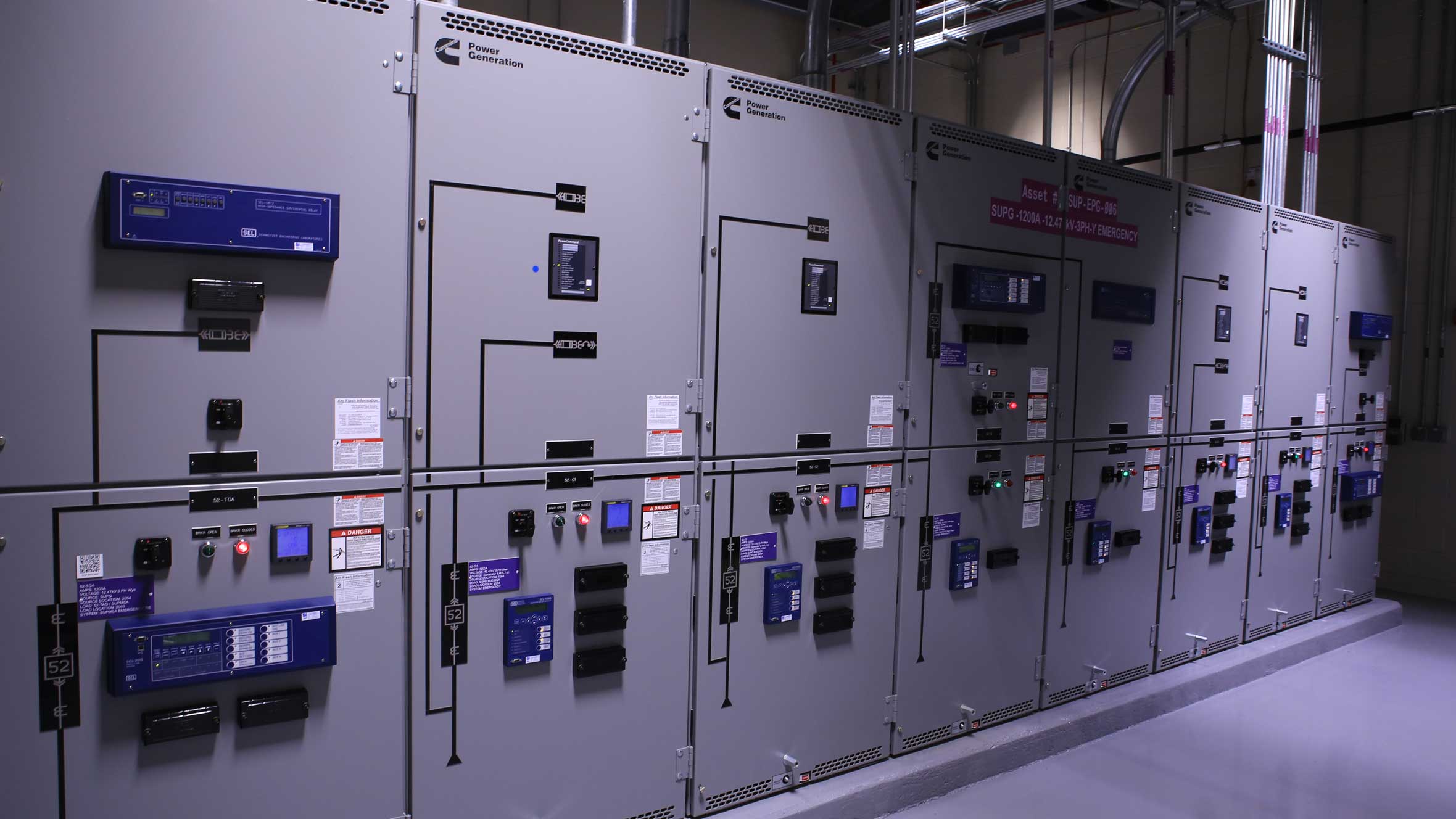 a long row of power generators in a dark room