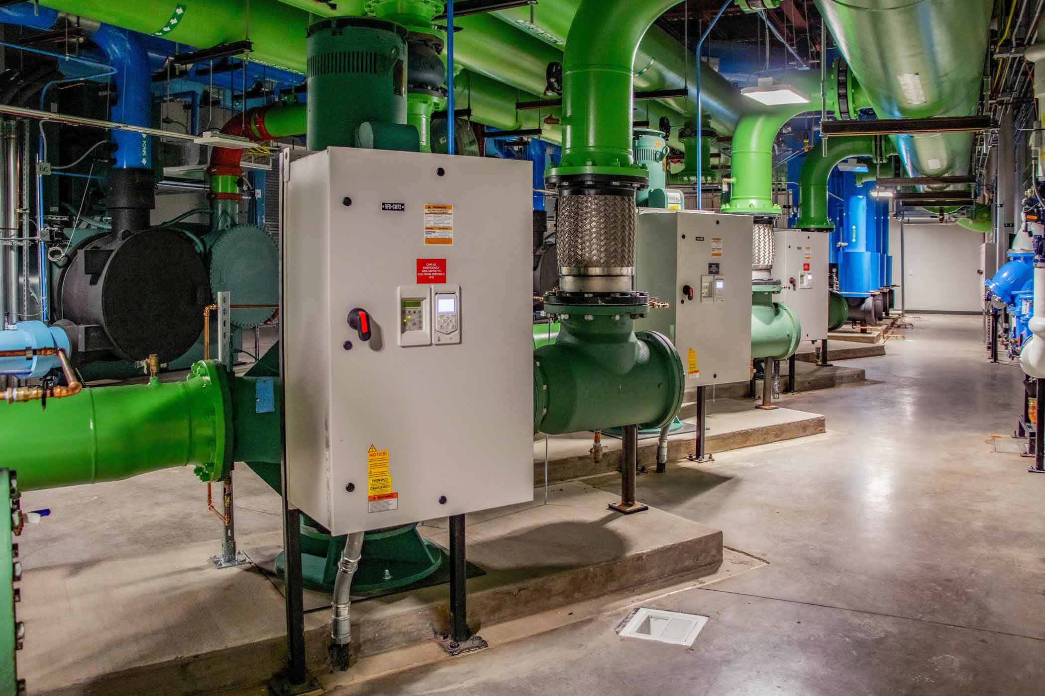 Medical boiler room with a view of piping and multiple panels