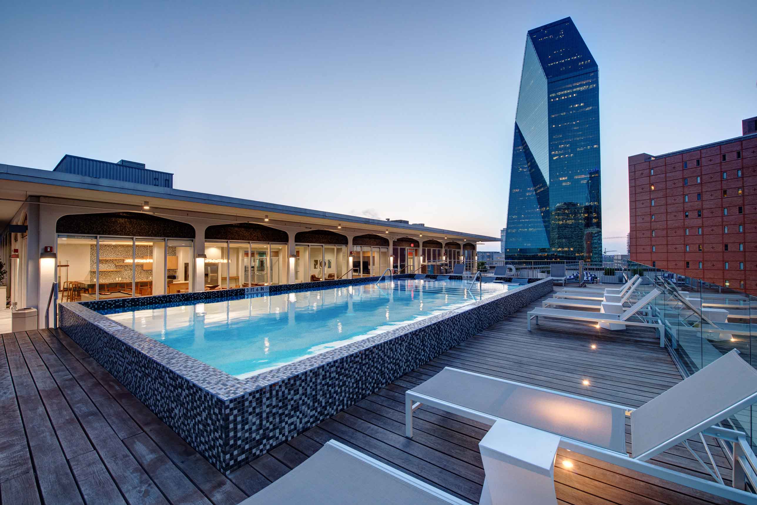 Modern elevated poolside view with a large high-rise building in the background