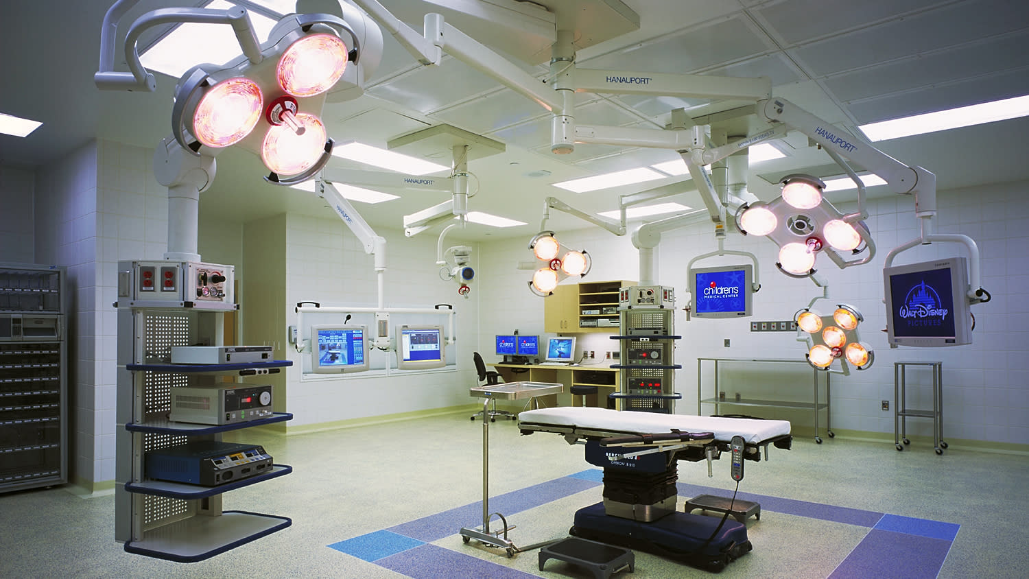 modern surgical room with multiple surgical lighting equipment illuminated