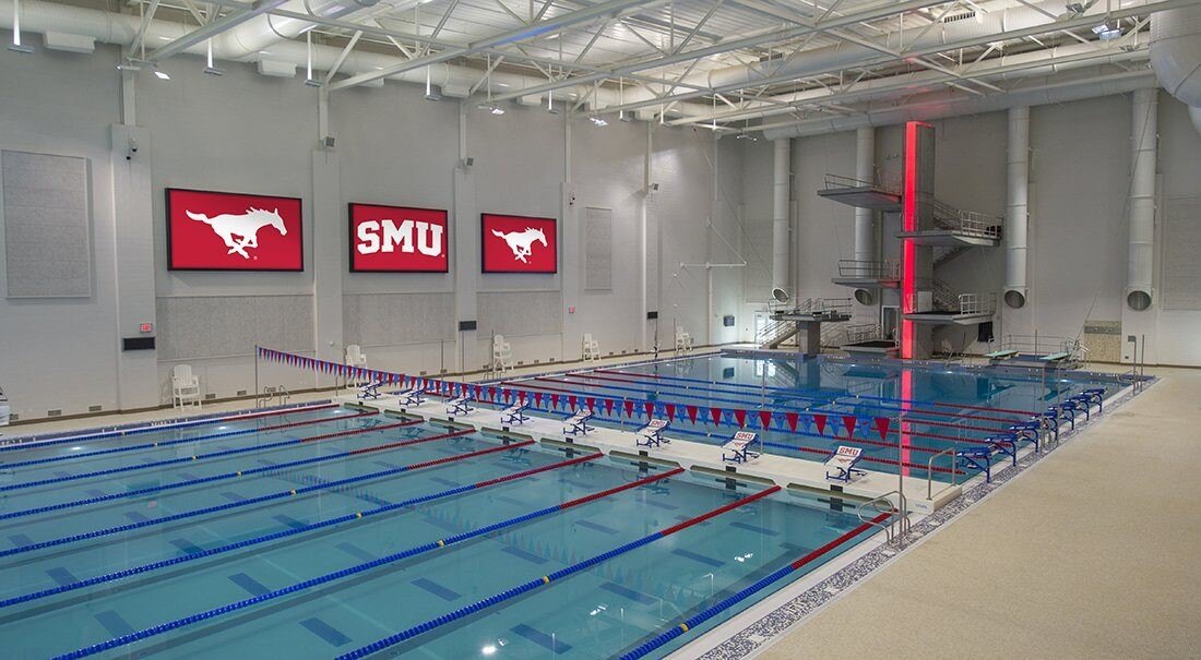 Indoor SMU pool building with multiple swim lanes and red screens with