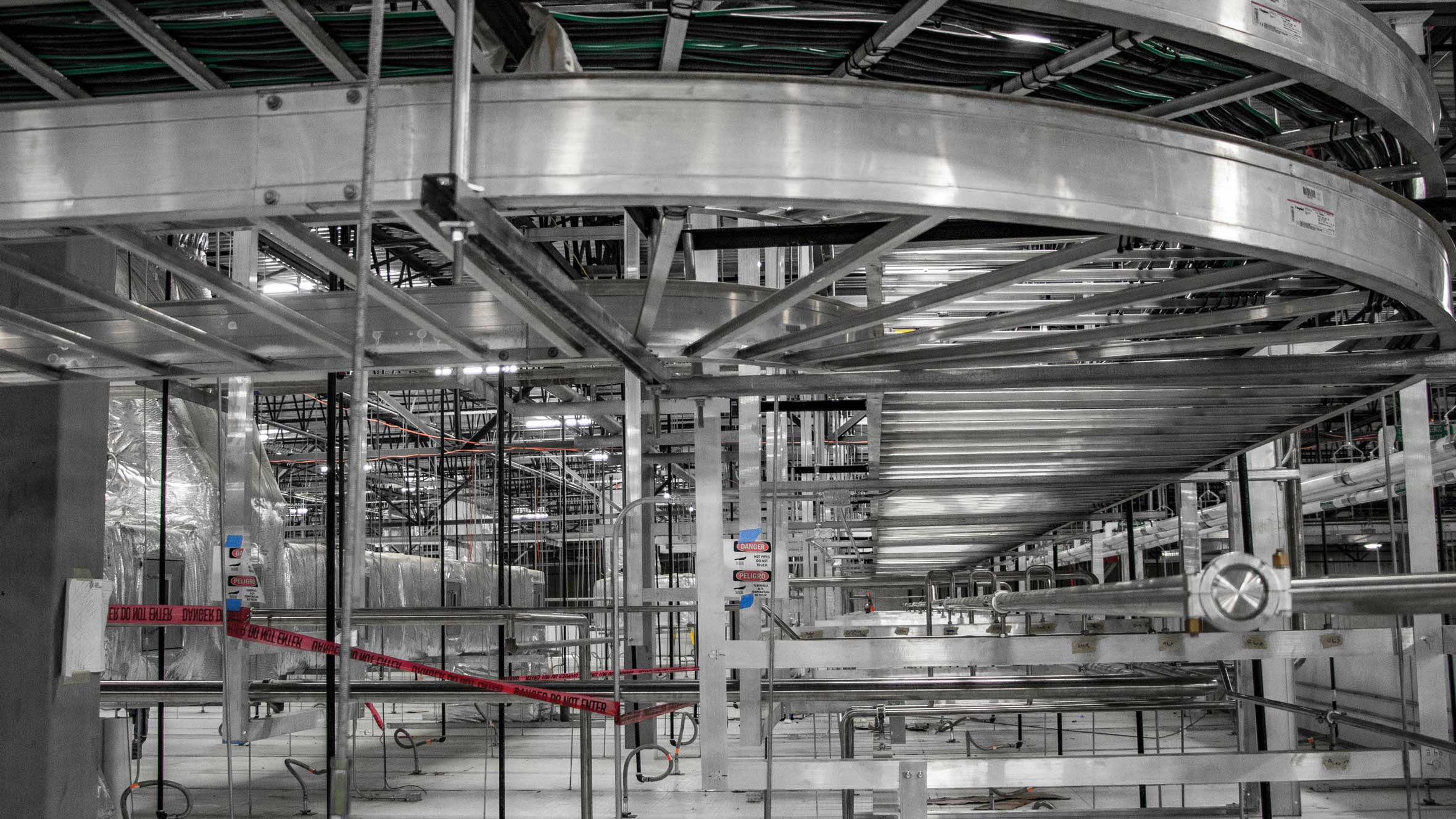 indoors manufacturing facility with metal conveyors 